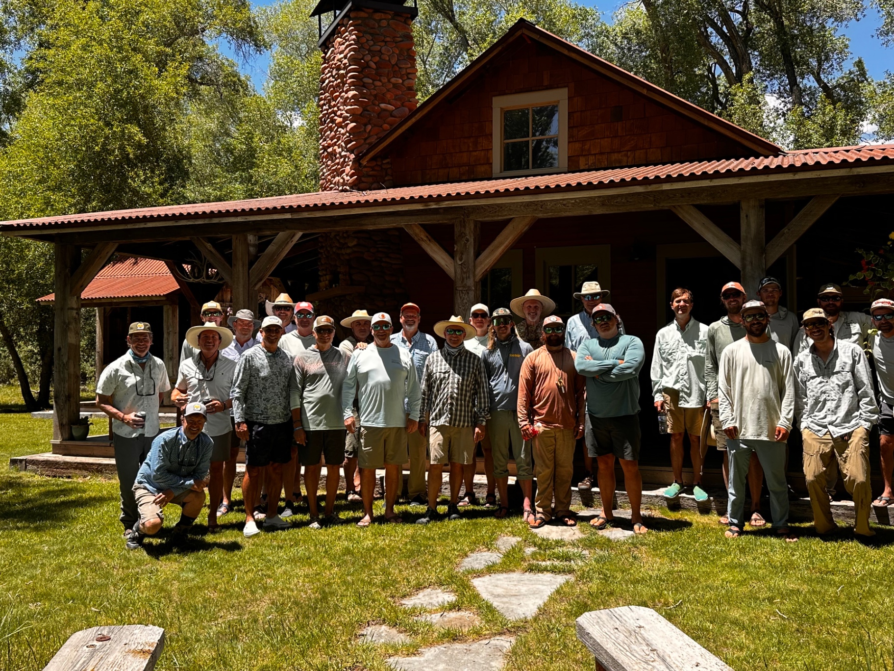 The Purple Helmet tournament group gathered in front of a rustic mountain lodge in Crested Butte, Colorado